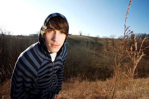 young man outdoors on a sunny winter day in the Ozarks - lens flare intentional