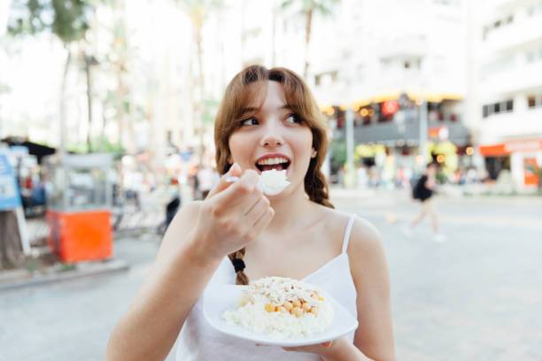 Beautiful People Eating Chicken on top of Rice.Turkey’s favorite street food . stock photo