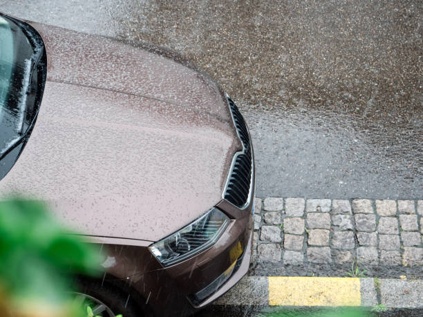Paris: View from above over new car covered with tiny hail during heavy rain bad weather in month of April in PAris, Europe