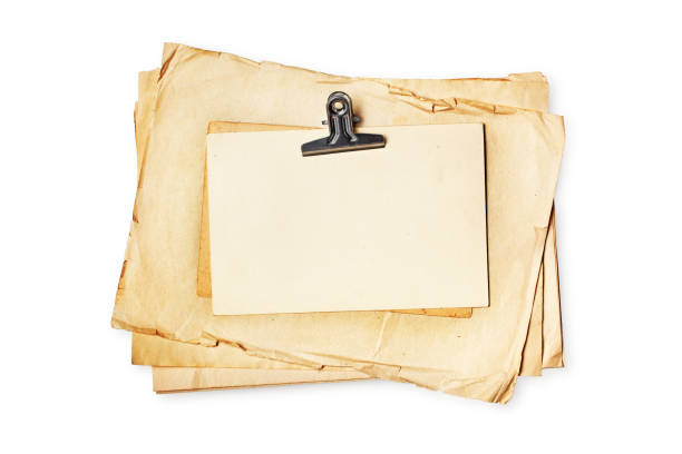 istock Mock up of empty old vintage yellowed paper sheets with binder clip 1151197729