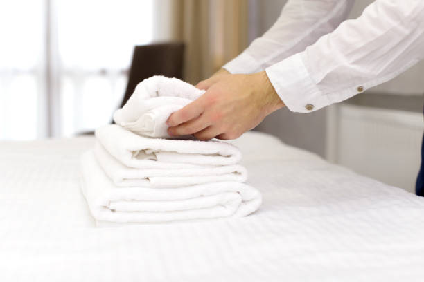 istock hotel staff setting up pillow on bed 1151197750