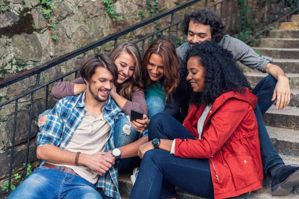 istock Multi-ethnic group of friends with smart phone 1151198414