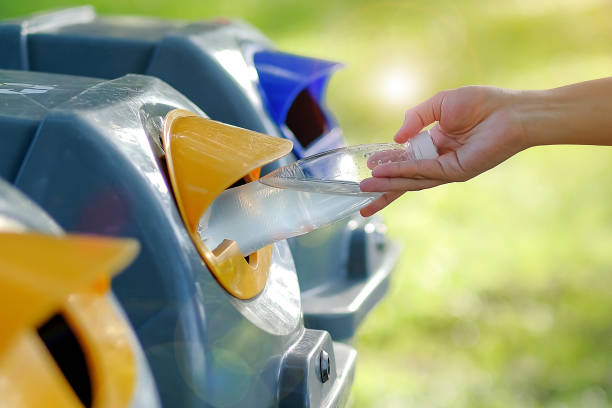istock Woman Hand throwing plastic water bottle in recycle bin 1151200685
