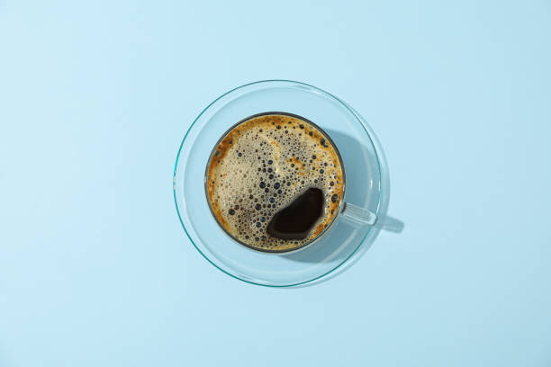 istock Cup of fresh coffee on color background, space for text and top view 1151201477