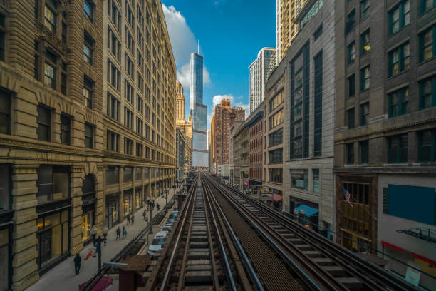 istock Elevated Train Tracks are running above the Railroad tracks between the building at the Loop line at Chicago, Illinois, USA 1151201756