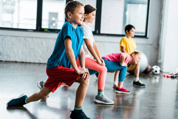 Kids warming up before training in gym stock photo
