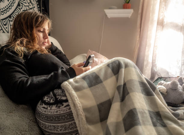 istock young woman relaxing with device 1151202212