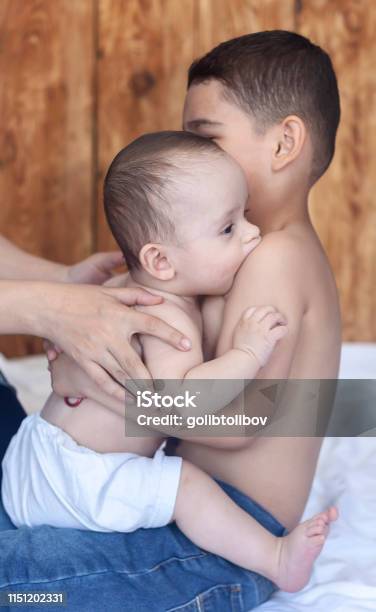 Happy Brothers Two Cute Little Brothers Lying On Bed Together Stock Photo - Download Image Now