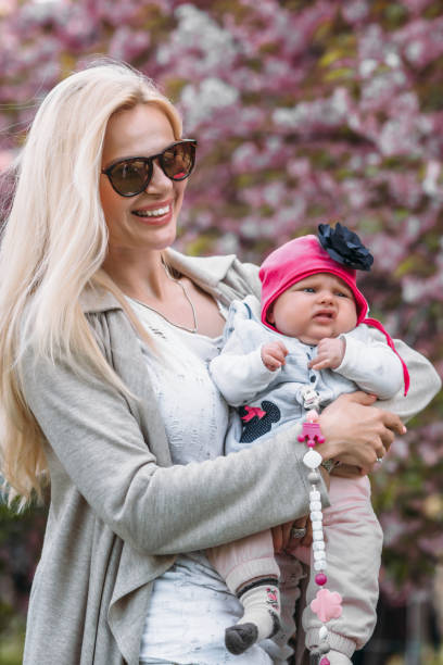 istock beautiful young mother walks with a small daughter 1151202726