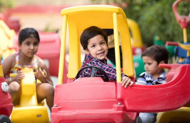 istock Children having fun playing on toy rides 1151203445