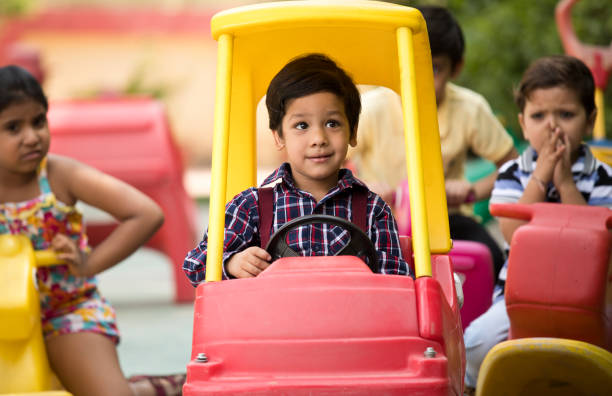 istock Children having fun playing on toy rides 1151203589