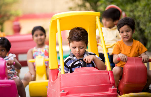 istock Children having fun playing on toy rides 1151203947