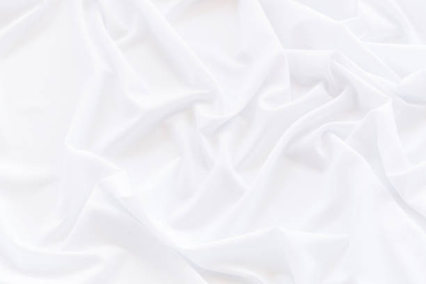 istock White fabric drapery, Crumpled white satin for background 1151204172