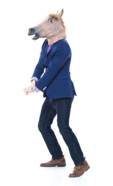 istock Businessman with horse mask is dancing 1151204373
