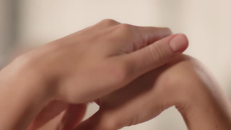 Close-up of woman caressing her smooth hands