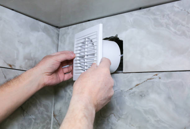 istock Man is installing the wall bathroom fan vent. Restoration process. 1151207474