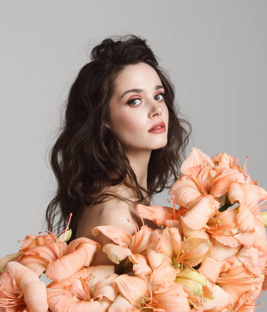 istock Beautiful young woman with flowers 1151207687