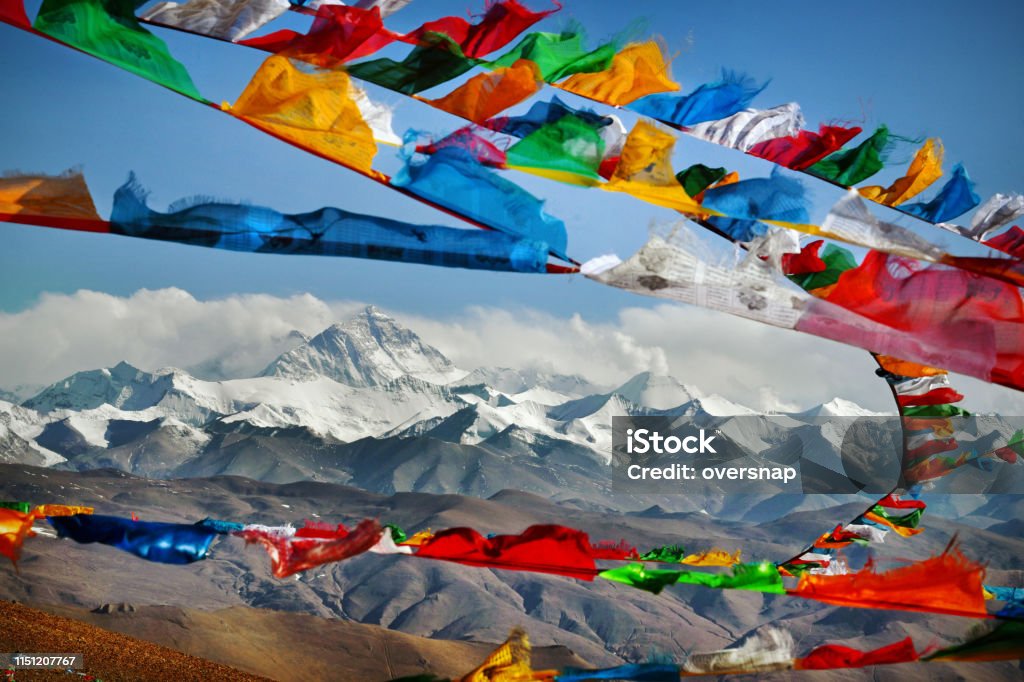 Mount Everest Mount Everest in Himalayas of Tibet viewed at distance through Buddhist prayer flags strewn across a high Himalayan Mountain pass
Everest, known in Nepali as Sagarmatha and in Tibetan as Chomolungma, is Earth's highest mountain above sea level, located in the Mahalangur Himal sub-range of the Himalayas. The international border between Nepal and China runs across its summit point Tibet Stock Photo