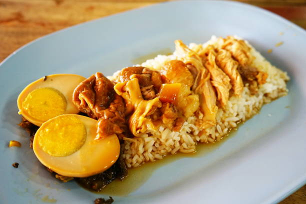 istock Stewed pork leg on rice with side dishes 1151207775