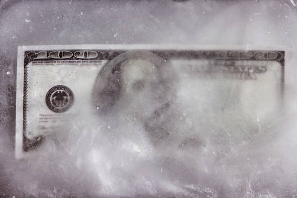 istock a dollar bill frozen in the ice. 1151207860