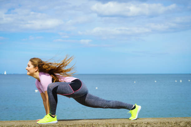 istock Woman stretching legs next to sea 1151209051
