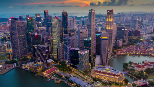 Day to night Hyperlapse or Dronelapse scene of Singapore business district downtown at sunset