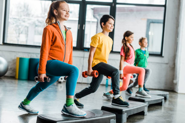 istock Preteen kids training with dumbbells and step platforms 1151211497