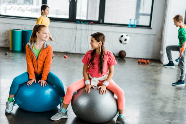 istock Kids talking while sitting on fitness balls 1151211506