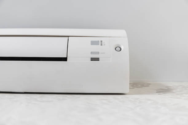 istock White air conditioner system on white wall in a room. 1151212613