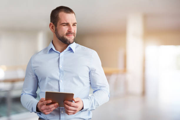 istock Man with tablet computer in the business center 1151215401