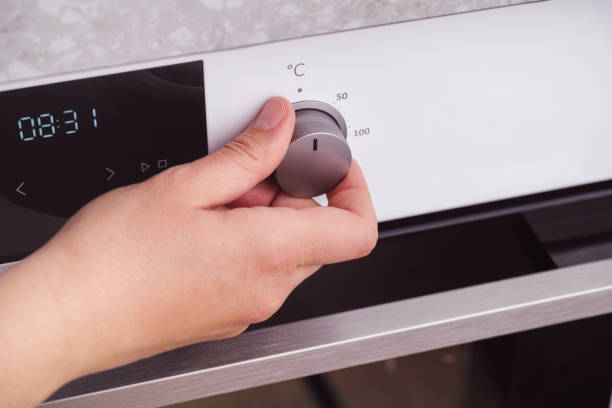 istock Person setting the temperature in celsius on the oven 1151216385