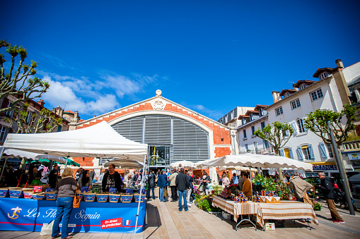 Biarritz, France - May 04, 2019: People shopping around Biarritz Market Hall, France