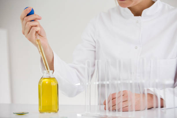 istock Female scientist in laboratory testing cbd oil extracted from a marijuana plant. She is using a glass dropper and a tubes for the experiment. Healthcare pharmacy from medical cannabis. 1151218618