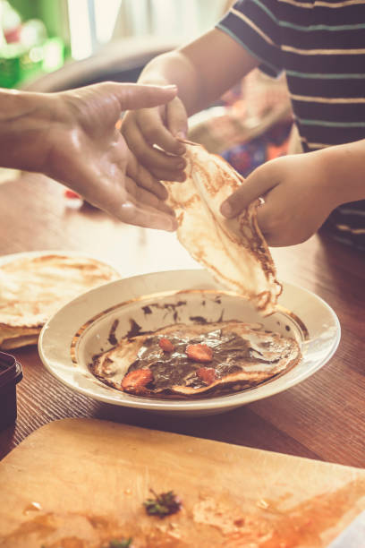istock A little boy with his mother preparing together a breakfast 1151223853