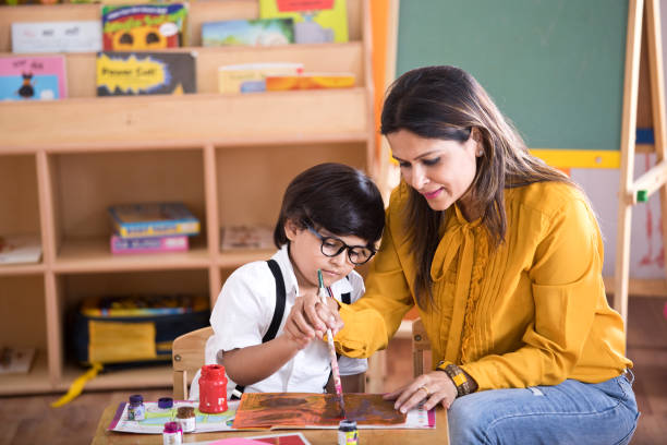 istock Children with teacher in drawing class 1151223900