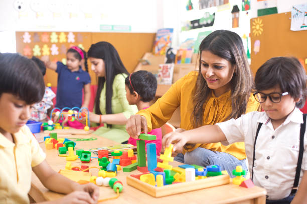 istock Teachers with children learning at preschool 1151223973