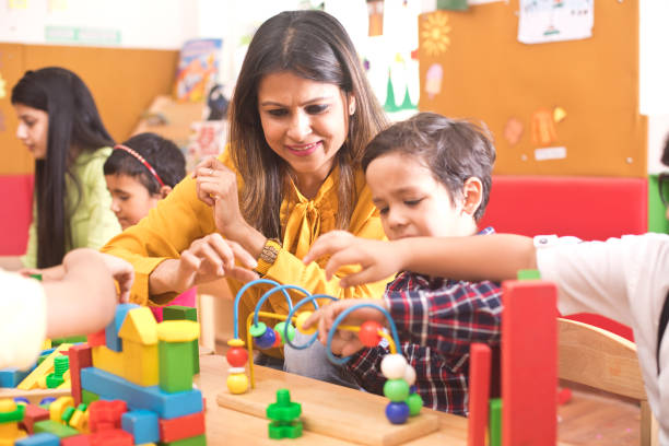 istock Teachers with children learning at preschool 1151224001