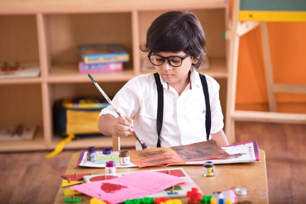 Indian boy drawing Little preschool boy drawing at classroom art class photos stock pictures, royalty-free photos & images