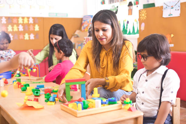 istock Teachers with children learning at preschool 1151224203