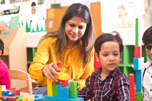 istock Teachers with children learning at preschool 1151224847