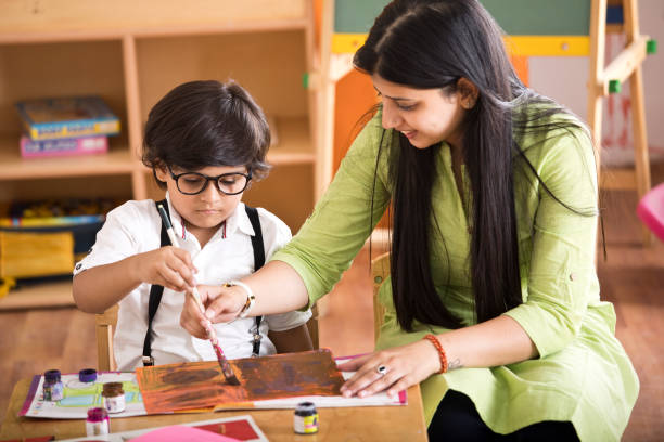 Children with teacher in drawing class