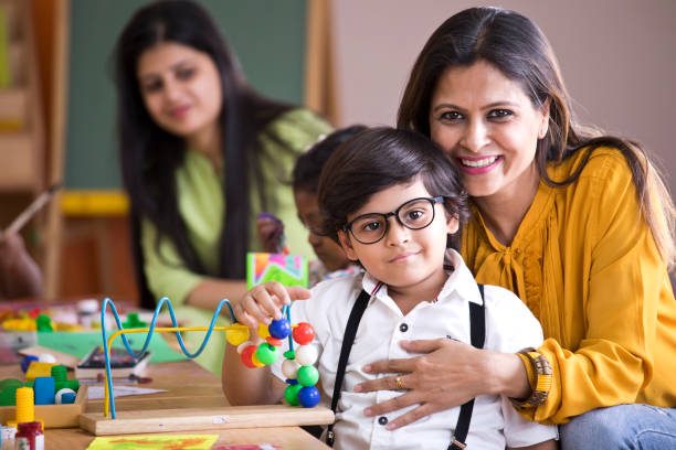 istock Teacher embracing preschool boy 1151224949