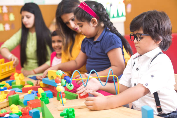istock Teachers with children learning at preschool 1151225153