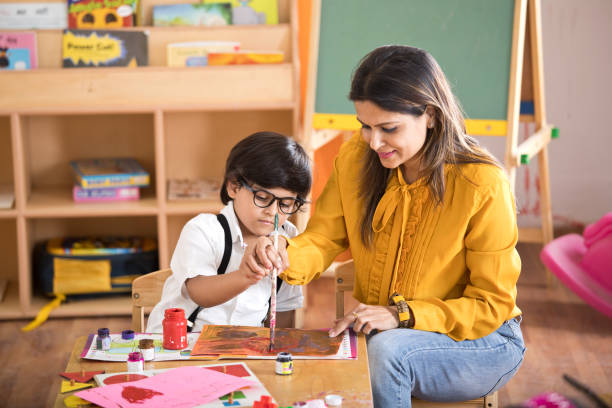 istock Children with teacher in drawing class 1151225899