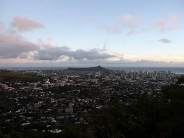The city of Honolulu from Diamond head to Manoa with Kaimuki, Kahala, and oceanscape visible on Oahu on a nice day at dusk viewed from high in the mountains.  Seen from Round Top Drive Lookout.  March 13, 2019.