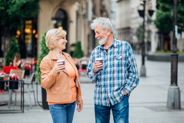 istock Mature couple drinking coffee to go 1151237922