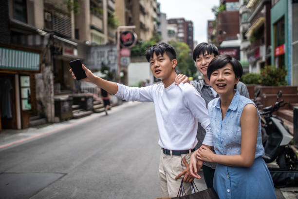 istock Three people are waiting for taxi service 1151241160