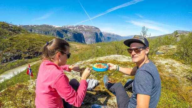 istock Norway - A young couple preparing meal in the wilderness 1151241488