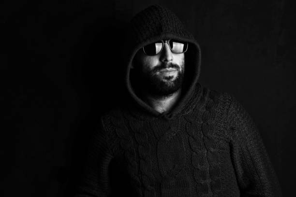 istock Man in glasses on black background 1151242948