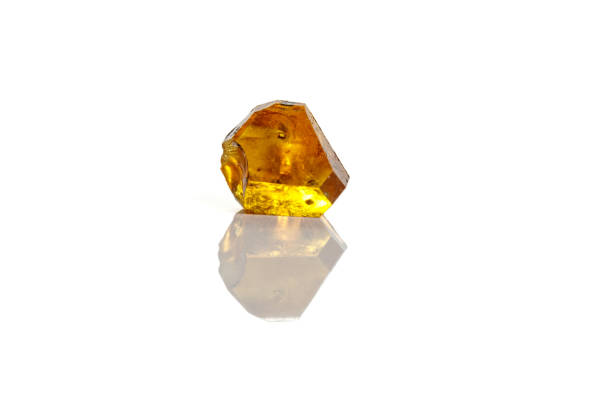 istock Macro yellow diamond mineral stone on white background 1151244470